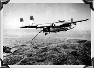 Troops dropping over the Korean hills from C-119